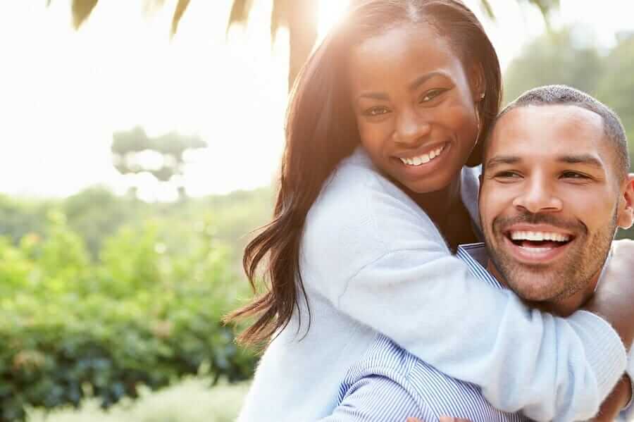 Who is considered a spouse or de facto spouse?